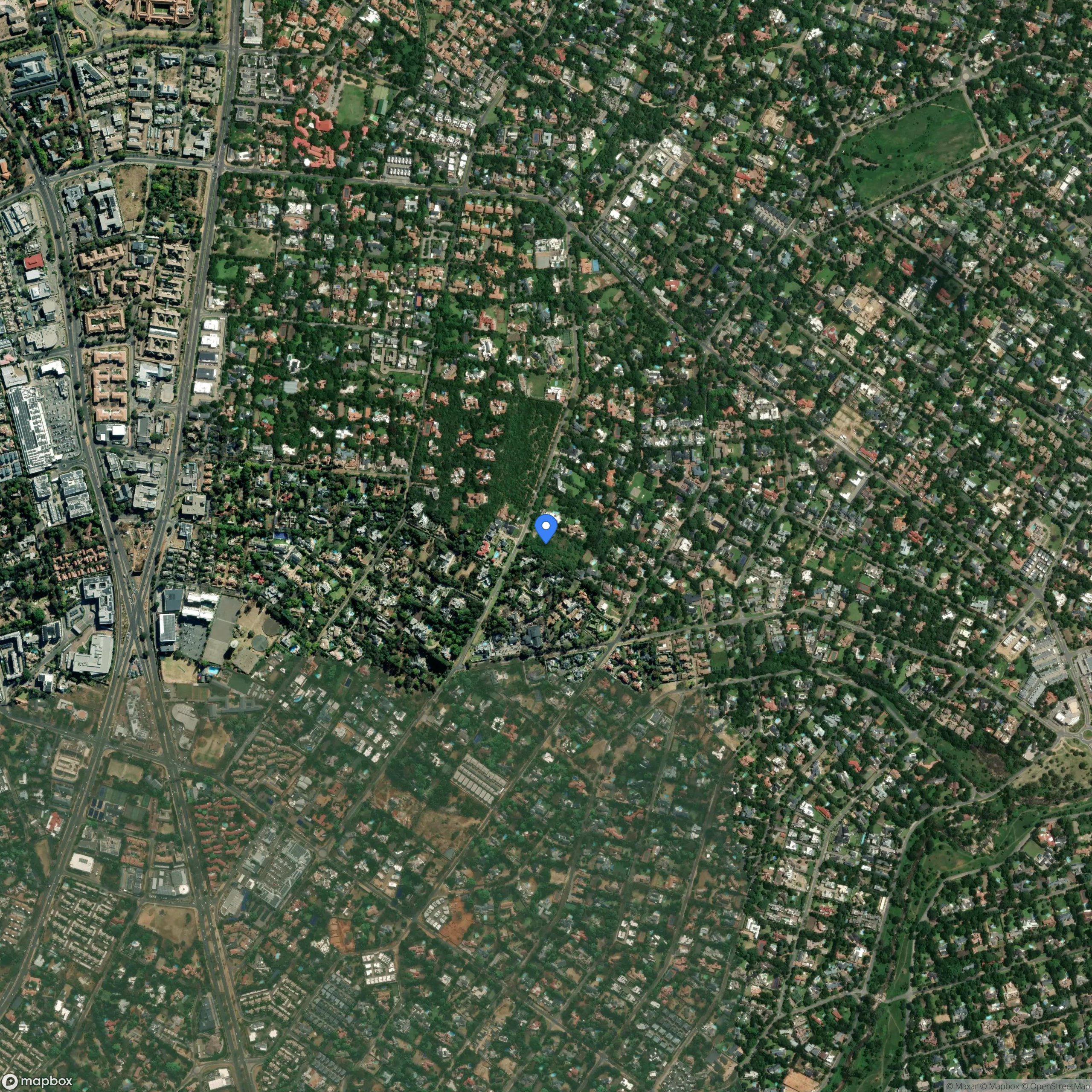 Open plot of land with small buildings scattered around